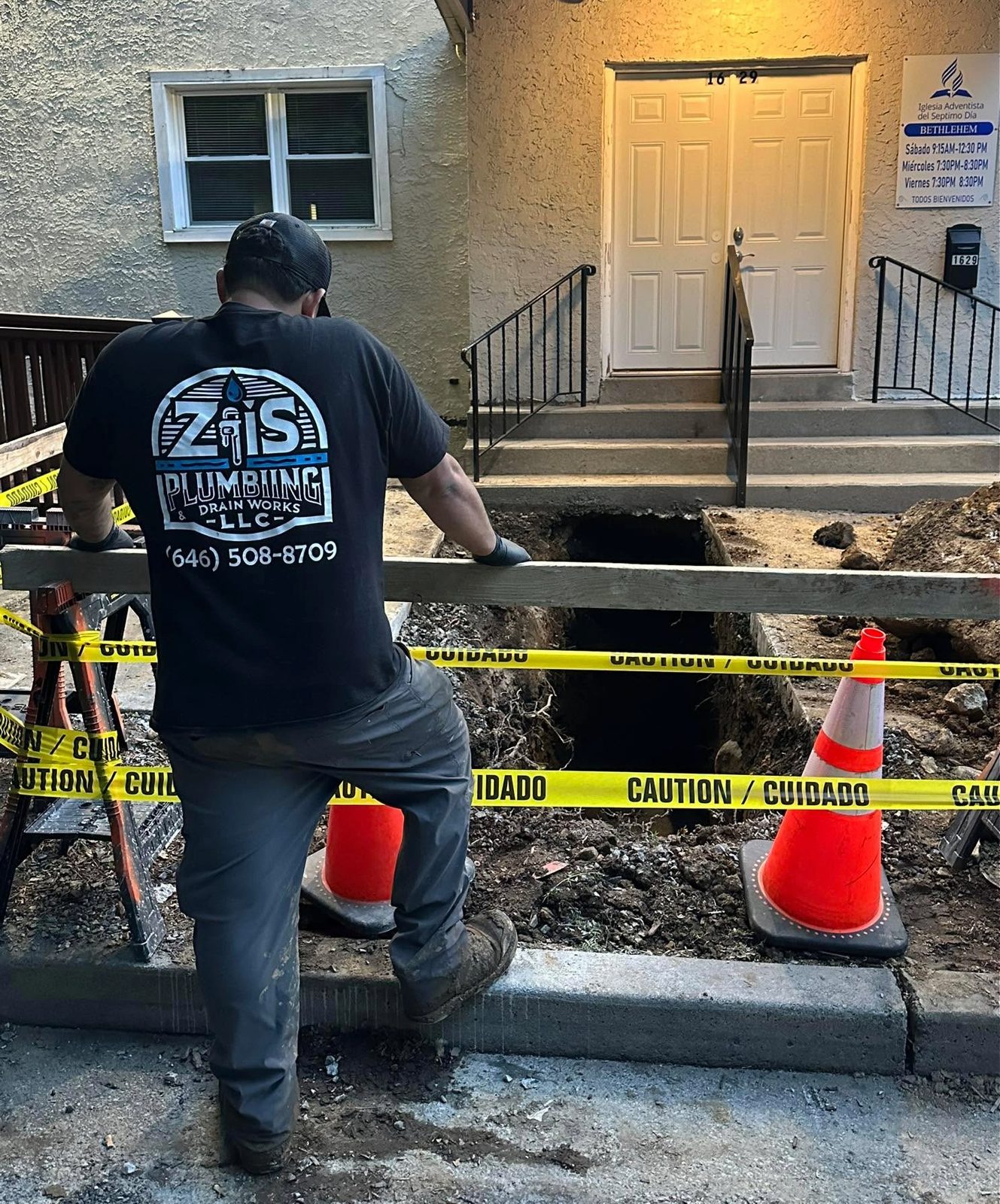 ZIS Plumbing technician at a residential excavation and sewer repair site