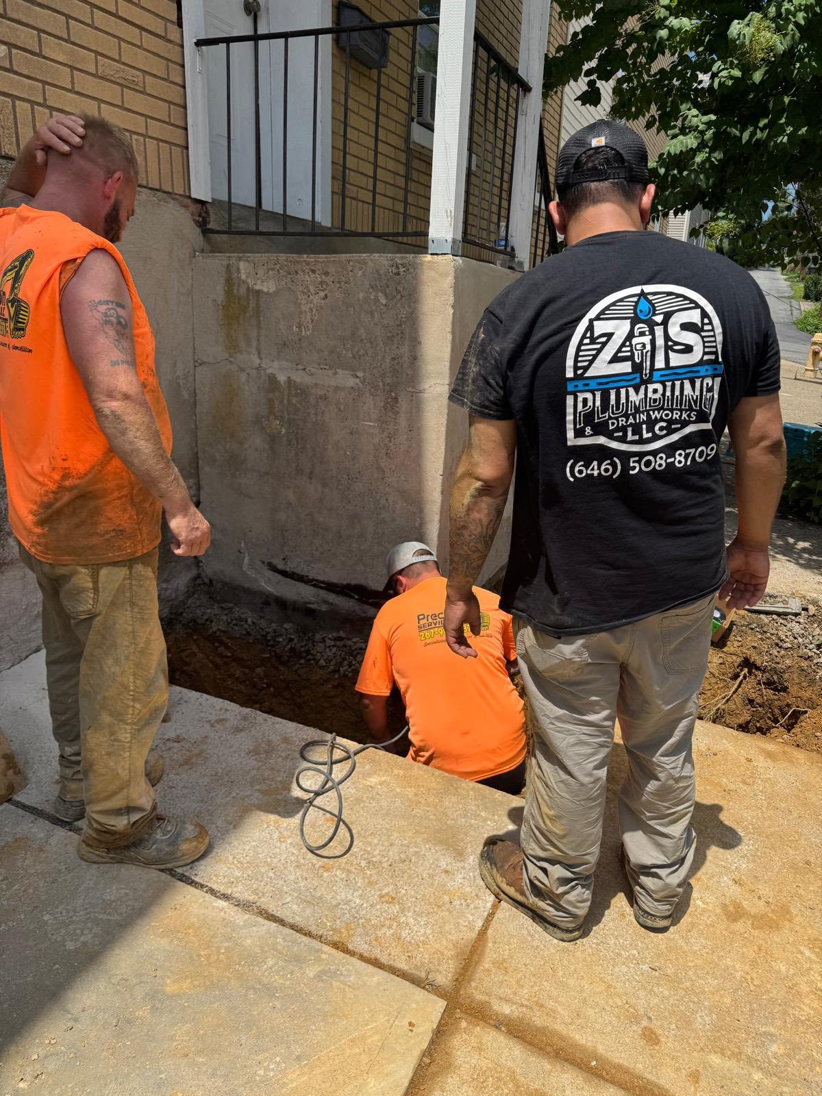 ZIS Plumbing crew working on a sidewalk utility repair