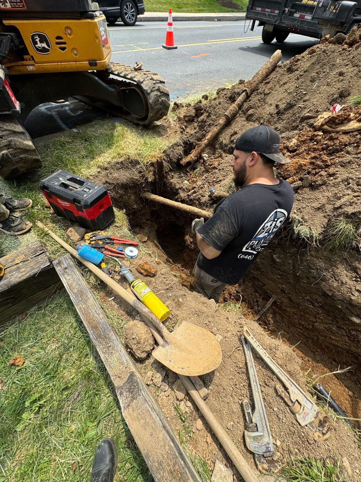 ZIS Plumbing crew member working in an excavated trench for a sewer line repair